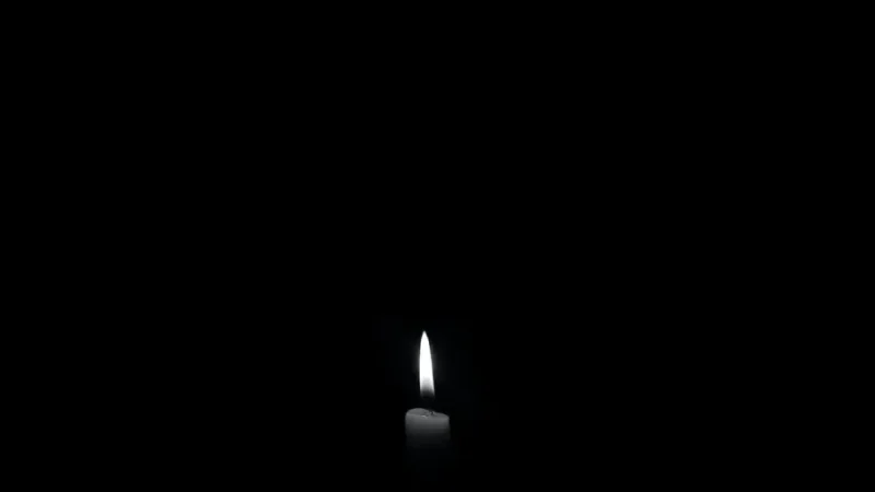 Luz de uma vela na escuridão.